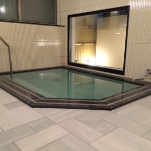 a swimming pool with a glass floor in a room at Jizokan Matsuya Ryokan in Nagano