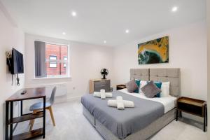 a white bedroom with a bed and a desk at Modern 1 Bedroom Apartment Town Centre Camberley in Camberley