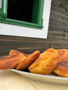 a plate of breads and hot dogs on a table at Casa Viorica- Pleta in Cîrlibaba