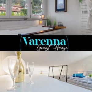 a kitchen with a bottle of wine and two glasses at Varenna Guest House in Varenna