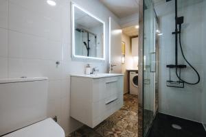 a bathroom with a sink and a toilet and a shower at Charming Apartment in the Heart of Triana, Seville in Seville