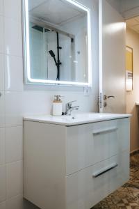 a white bathroom with a sink and a mirror at Charming Apartment in the Heart of Triana, Seville in Seville