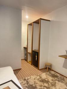 a bedroom with a closet and a bed and a table at De Hope Kohlanta in Ko Lanta Yai