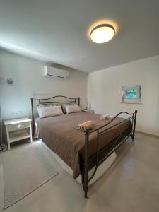 a bedroom with a large bed and a lamp at Moderne Villa mit Pool in Sant Josep de Sa Talaia +14 photos