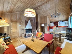 a living room with a table and a fireplace at Cozy cabin in Geilo in Geilo +15 photos