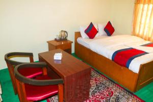 Ένα ή περισσότερα κρεβάτια σε δωμάτιο στο Hotel Village Inn