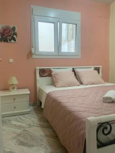 a bedroom with a large bed and a window at Villa Andrea in Skala Potamias