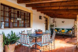 a room with a table and chairs and a couch at Can Bleo in Pollença
