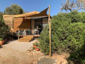a small house with a tent in a yard at Montinho Boutique Studio in Benagil