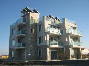 a tall building with balconies on the side of it at Вила Арапя in Tsarevo