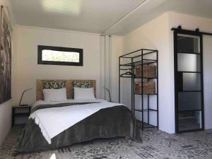 a bedroom with a bed and a book shelf at Montinho Boutique Studio in Benagil
