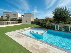a swimming pool in the backyard of a house at La Dune 54 - Villa 3P6 in Valras-Plage +18 photos