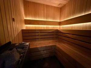 a wooden sauna with a bench in the middle at Askana in Białka Tatrzańska