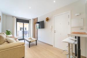 a living room with a couch and a table at Gala Holidays City Center and Beach in Fuengirola