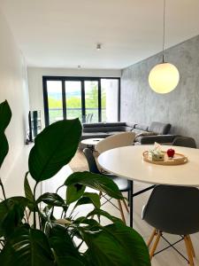 a living room with a table and chairs at Apartmán NAUTIS in Piešťany