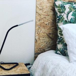 a lamp sitting on a table next to a bed at Montinho Boutique Studio in Benagil
