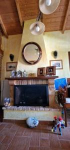 a living room with a fireplace and a mirror at Αρχοντικό Κορκόντζελου in Nafpaktos