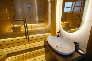 a bathroom with a sink and a shower at BOROVI PRESIDENT SPA Apartment in Divčibare +60 photos
