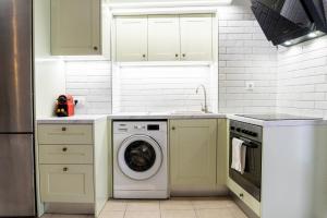 a kitchen with a washing machine and a dishwasher at Nina's Traditional House By Estia in Valaneíon +18 photos