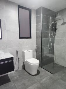 a bathroom with a toilet and a glass shower at CasaPutra by MySky Stays Putrajaya in Putrajaya +12 photos