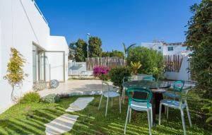 a patio with a table and chairs in a yard at Villa Italy in Playa d'en Bossa