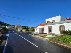 an empty street next to a white house at Salmoura's Place AL 4724 in Santa Cruz das Flores +15 photos