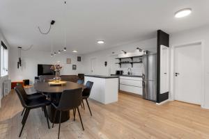 a kitchen and dining room with a table and chairs at Spacious 3Bedroom Apartment on Rainbow Street in Reykjavík
