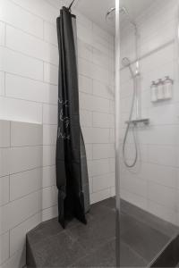 a shower with a black shower curtain in a bathroom at Spacious 3Bedroom Apartment on Rainbow Street in Reykjavík +16 photos
