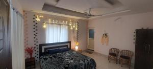 a bedroom with a bed and a table and chairs at SAMANI Homestay in Rishīkesh