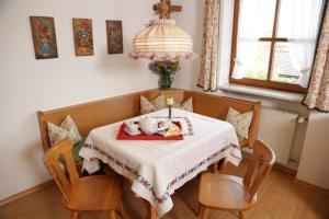 a dining room with a table with a stuffed animal on it at Landhaus Kauderer - Wohnung 1 in Waging am See