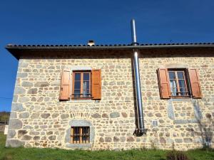 a stone building with two windows on it at L'Auberge de la Source in La Valla