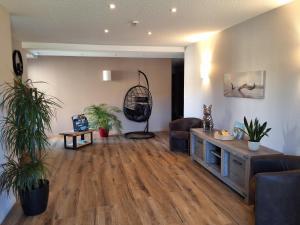 a living room with a couch and a chair at L'Auberge de la Source in La Valla +19 photos