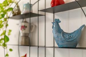 a shelf with a blue chicken on it at MCH-Marina Charming House in Cagliari