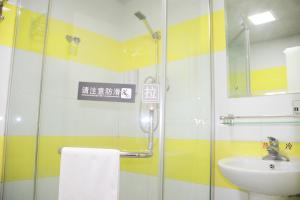 a bathroom with a glass shower and a sink at 7Days Premium Guangzhou Kecun Subway Station in Guangzhou