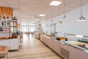 a kitchen with a long line of counters in a restaurant at Port Europa in Calpe