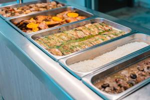 a buffet line with several trays of food at Port Europa in Calpe