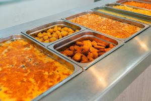 a buffet with several trays of food on a counter at Port Europa in Calpe