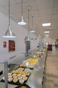 a buffet line with many different types of donuts at Port Europa in Calpe