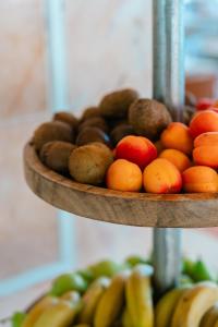 a plate of fruit on a shelf with fruits at Port Europa in Calpe