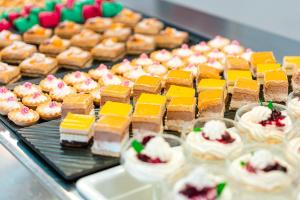 a display case with many different types of cakes and pastries at Port Europa in Calpe