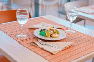 a plate of food on a table with two wine glasses at Port Europa in Calpe