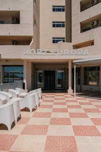 a building with benches in front of a building at Port Europa in Calpe