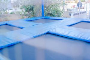a group of blue tramp trampolineqs on a patio at Port Europa in Calpe