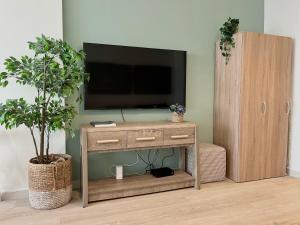 a wooden entertainment center with a television on a wall at Boutique Studio in Palm Jumeirah - Stunning View in Dubai