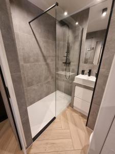 a bathroom with a shower and a sink at Własne M Studio in Konin +6 photos