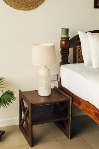 A bed or beds in a room at Neevana Hotel Hikkaduwa