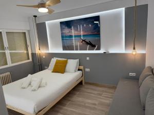 a bedroom with a bed with a painting on the wall at Apartamentos Alcorcón in Alcorcón