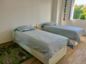 two twin beds in a bedroom with a window at Villa Ischia Vue Mer in Bandol +25 photos