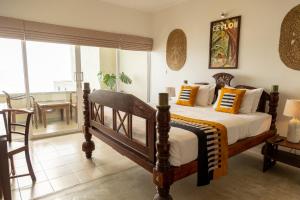 A bed or beds in a room at Neevana Hotel Hikkaduwa