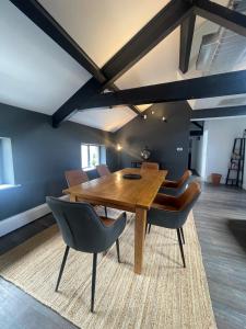 a dining room with a wooden table and chairs at The Turret, Central Apartment in Hebden Bridge
